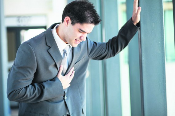 young businessman having chest pain